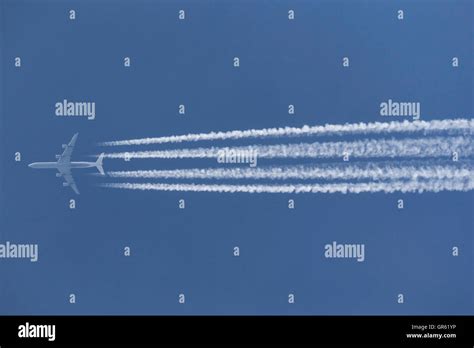 Airbus A340 Airliner Flying At High Altitude With Contrails Streaming