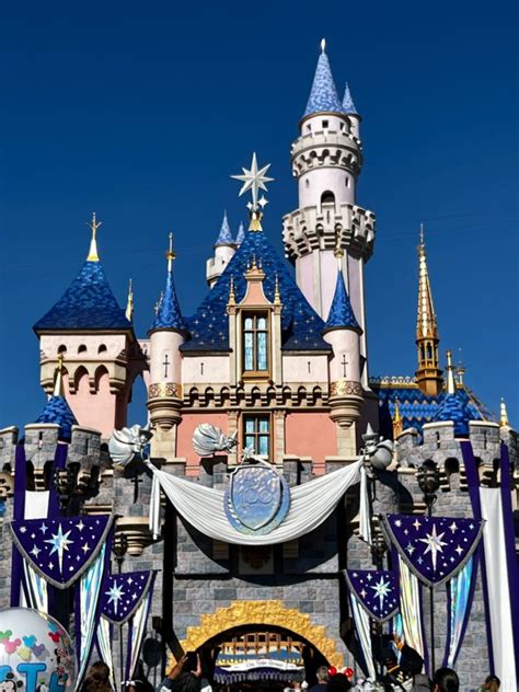 100th anniversary bunting adding to sleeping beauty castle at disneyland