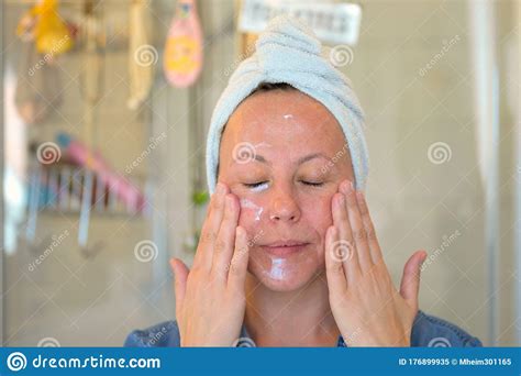Woman Massaging Moisturiser Into Her Face Stock Image Image Of Eyes