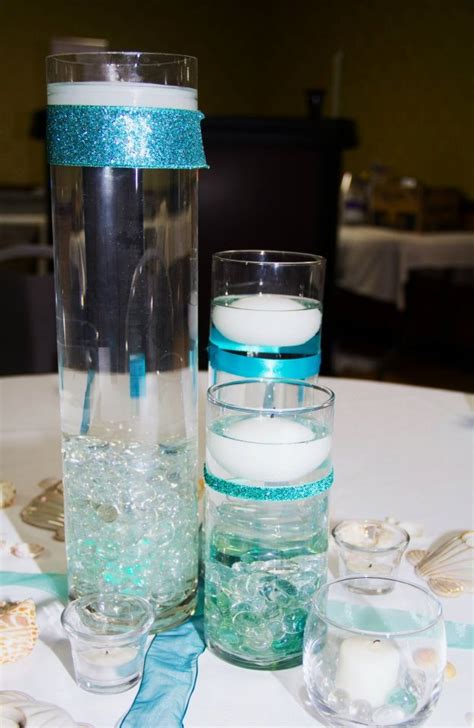 Centerpiece With Floating Candles Colored Stones To Represent Sea Glass And Seashells For A B