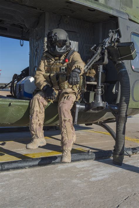 The Door Gunner Of A Griffon Helicopter Rests Before A