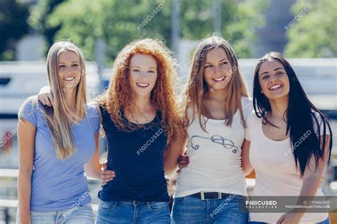 Group Picture Of Four Friends On The Street — Female Friends Smiling
