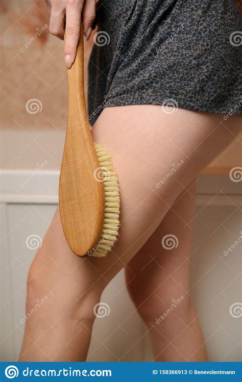 Woman Makes Massage Legs With Wooden Soft Massage Brush For Body And