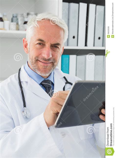 Male Doctor Using Digital Tablet At Medical Office Stock Photo Image