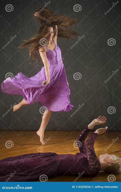 Two Young Women Dancing On Hardwood Floor In The Studio Stock Photo