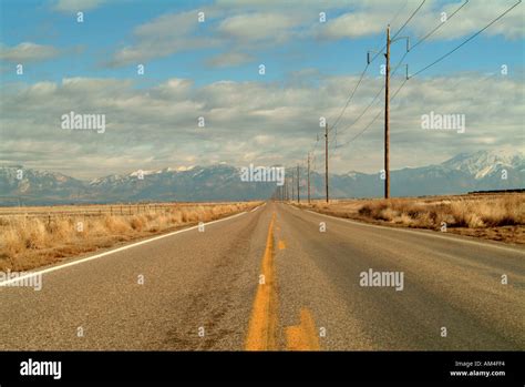 Long Desert Road Leading Towards The Mountains Stock Photo Alamy