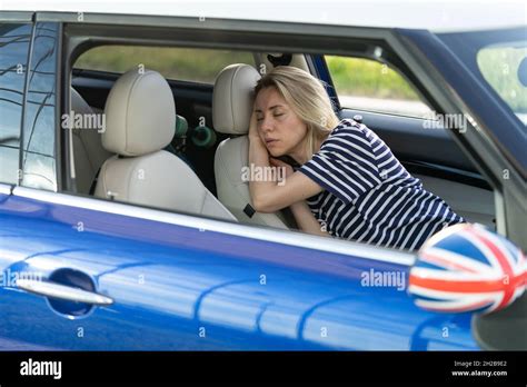 tired woman sleep inside car on driver seat unhappy adult female fall asleep on parking after
