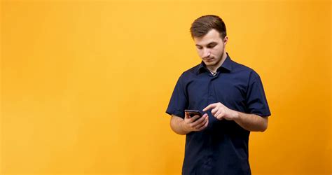 Caucasian Young Man Holding A Phone In Hands With Green Screen On It