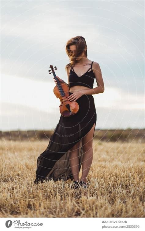 Pretty Woman With Violin On Field A Royalty Free Stock Photo From Photocase