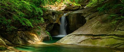 Download Wallpaper 2560x1080 River Waterfall Cliff Stone Trees Dual