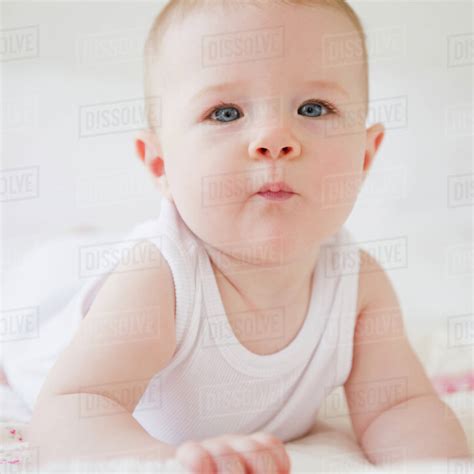 Baby Lying On Bed Stock Photo Dissolve
