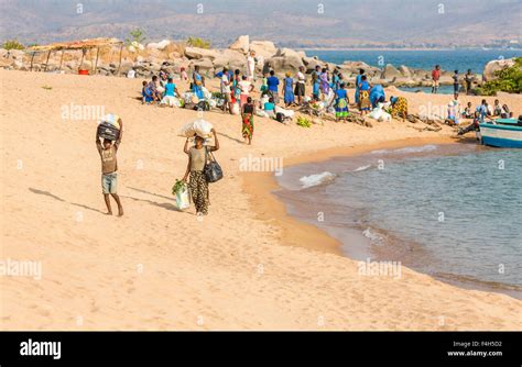 Local People Unloading Goods From A Boat On The Lakeside Beach Likoma