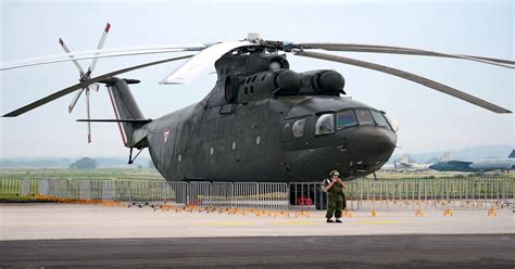 Share the best gifs now >>>. Mexican soldier stands next to a Mi-26 helicopter ...