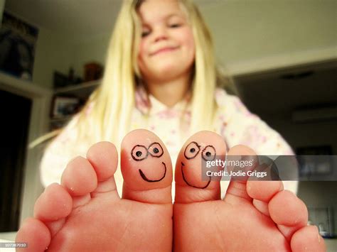 Girl With Smiley Faces Drawn On Toes High Res Stock Photo Getty Images