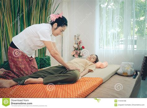 Professional Therapist Giving Traditional Thai Massage To A Woman In Spa Center Healthy Concept