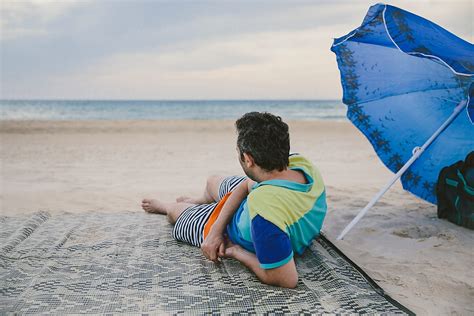 Man Resting On The Beach By Stocksy Contributor Lior Lone Stocksy