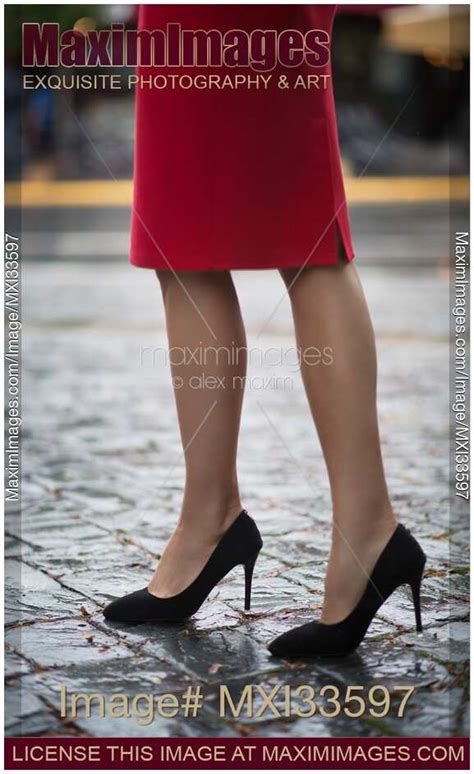 Photo Of Closeup Of Sexy Woman Legs In High Heel Shoes And Red Dress Walking On Cobbled City