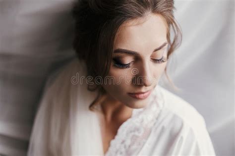 Gorgeous Beautiful Bride In Silk Robe Posing Near Window In Soft Stock