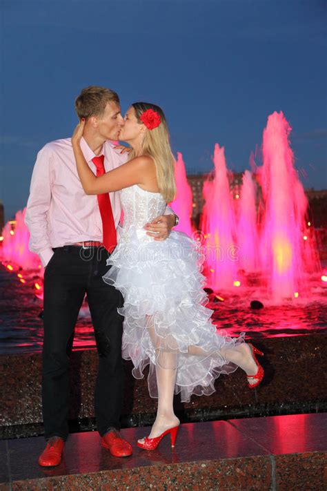Bride And Groom Kiss Near Pink Fountains Stock Photo Image Of Hand