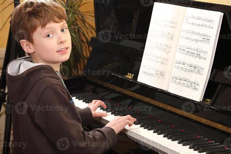 Boy Play Piano 1242048 Stock Photo At Vecteezy