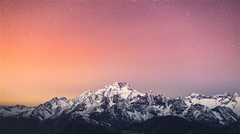 1366x768 4k Starry Sky Above Snow Covered Mountains 1366x768 Resolution