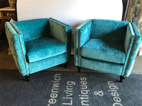 Equipped with a head rest, reclining action and a side tray for food and drinks, this chair is perfect for all your sideline needs! Pair of Mid-Century Modern Style Teal Tufted Oversized Box Form Armchairs For Sale at 1stdibs