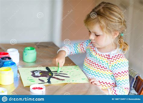 Little Creative Toddler Girl Painting With Finger Colors