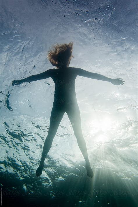 Silhouette Of Woman Floating In Lake By Stocksy Contributor Jp Danko
