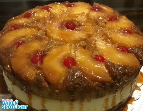a cake with pineapples and cherries is on a plate ready to be eaten