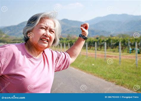 asian elderly woman asking for help private cars run out of gas during the journey stock image