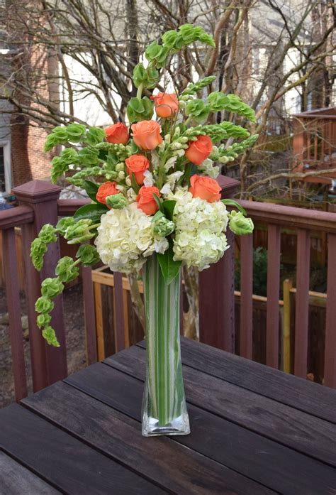 tall contemporary arrangement with hydrangeas parrot tulips roses bells of irela… hydrangea