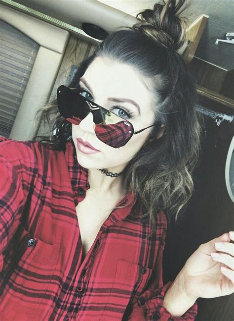 A Woman In Plaid Shirt And Black Sunglasses