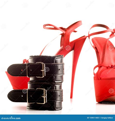 Bdsm Outfit For Adult Sex Games Red High Heeled Striptease Shoes And Handcuffs Isolated On A