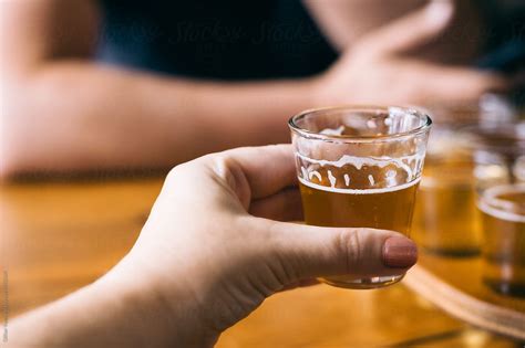 A Womans Hand Holds A Beer During A Tasting In A Brewery Stocksy