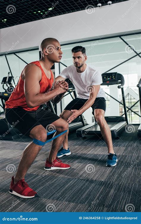 Attentive Trainer Supporting African American Sportsman Stock Photo