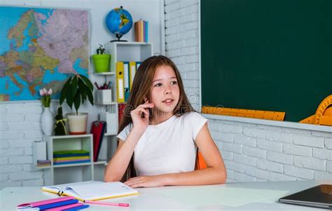 Teen Girl Sit At Table In Classroom Back To School Concept Of