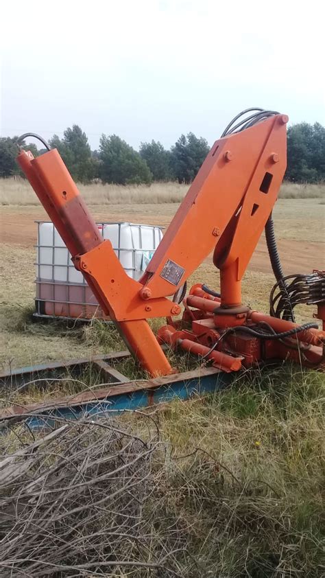 Mail crane — an upright post planted close to a railroad track with an arm which, when not in use, hangs by the side of the post, but when in use is extended horizontally toward the track. Pesci Crane for sale or Hire | Junk Mail