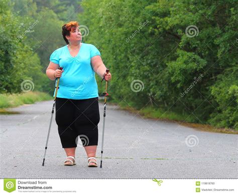 Overweight Woman Walking On Forest Trail Stock Photo