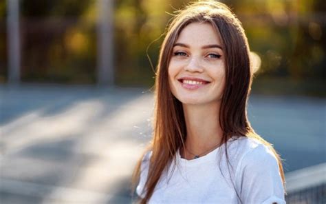 Smiley Grey Eyes Girl Model Is Standing In Blur Bokeh Background Wearing White Dress Hd Girls