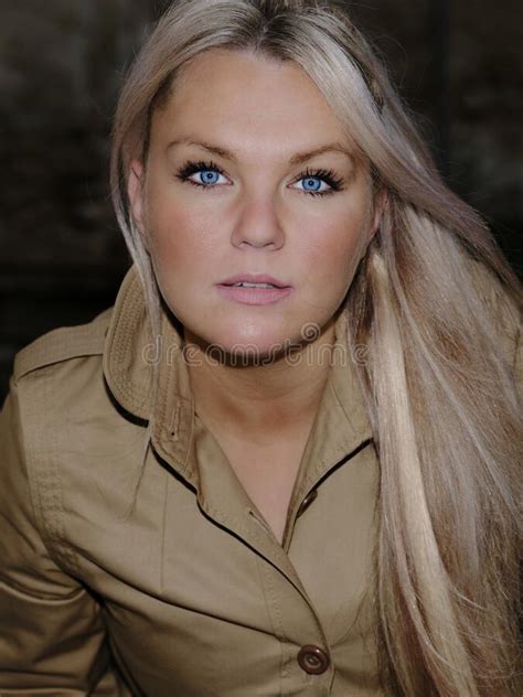 Portrait Of A Beautiful Young Woman With Blue Eyes And Blond Hair Stock