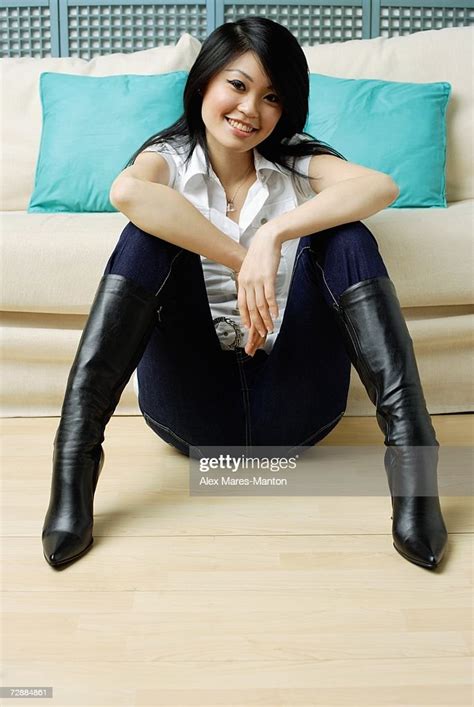 Young Woman Sitting On Floor Legs Apart Hands On Knees High Res Stock