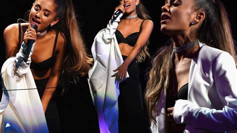 ariana grande reveals bra on stage but gets in a tangle with her jacket while undressing