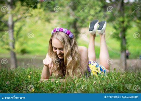 Beautiful Blonde Girl Lying On The Grass And Smiling Stock Image