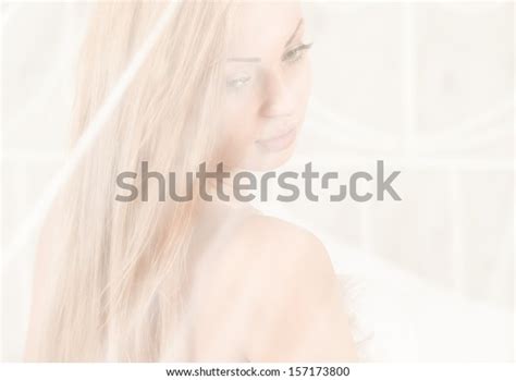 sexual blond woman lying naked in bed