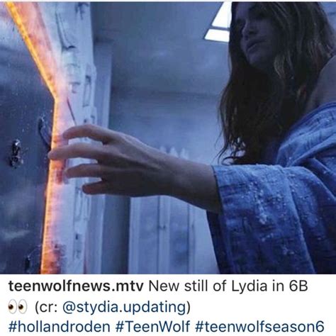 a woman holding something in her hand and looking at it with the caption teenwolfews new still