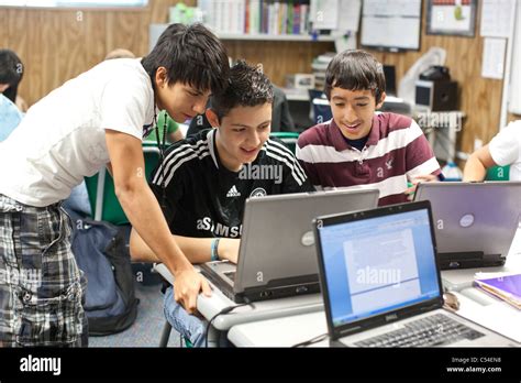 Hispanic Male Students Work Together On Laptop Computer In El Paso