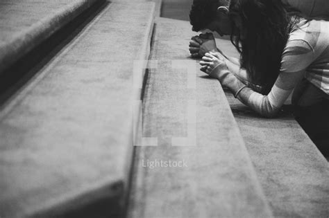 A Man And Woman Kneeling In Prayer At An Altar — Photo — Lightstock
