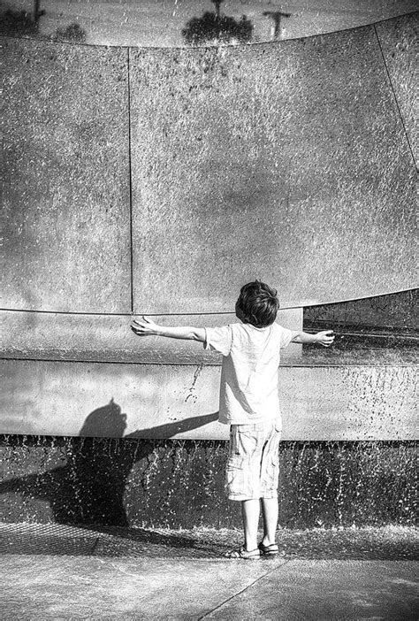 Boy Cooling Off Under A Fountain Photograph By Dariusz Janczewski