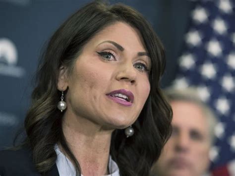 — standing before an america uncanceled banner in a pink dress, south dakota gov. Rep. Kristi Noem's Defense of Her Estate Tax Deceptions: A ...