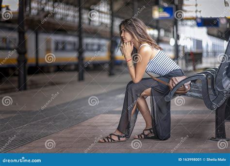 Girl Tourist Waiting Patiently On The Train Platform Stock Image